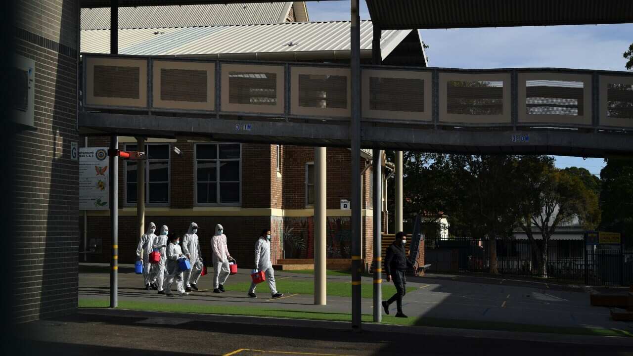 Workers conduct a deep clean at Carlton Public School in Sydney on 23 August 2021. 