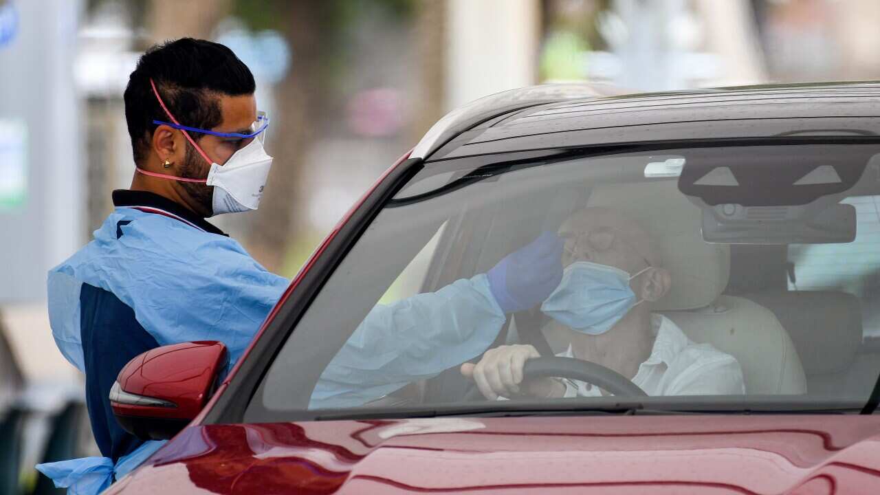 Healthcare workers administer COVID-19 tests at the St Vincent’s Hospital drive-through clinic in Sydney.