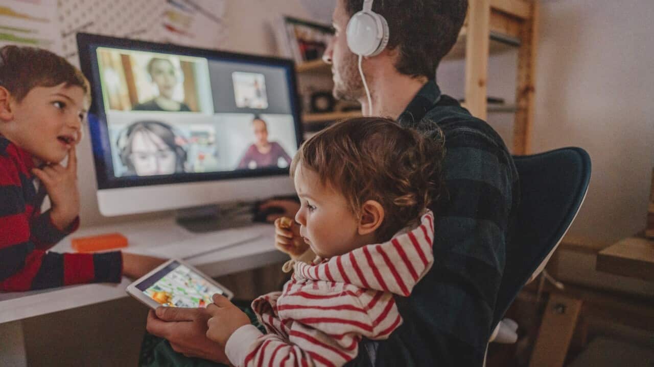 Dad with two kids attending a virtual meeting