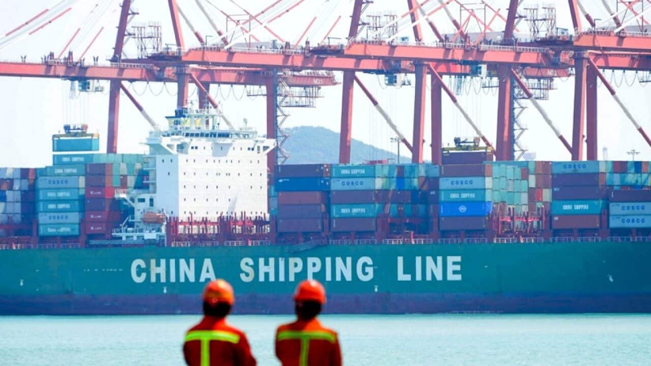 Containers are loaded into a cargo ship in Qingdao, China