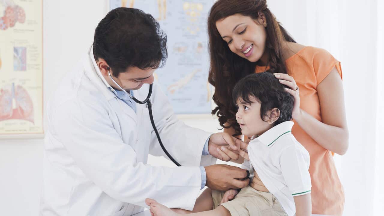 Doctor examining a baby boy with a stethoscope