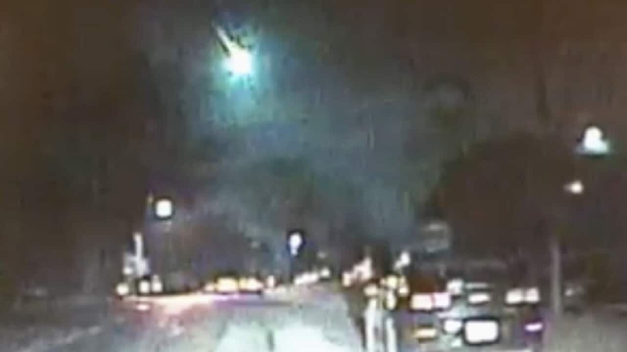 A dashcam still of a meteor as it streaked over Lake Michigan