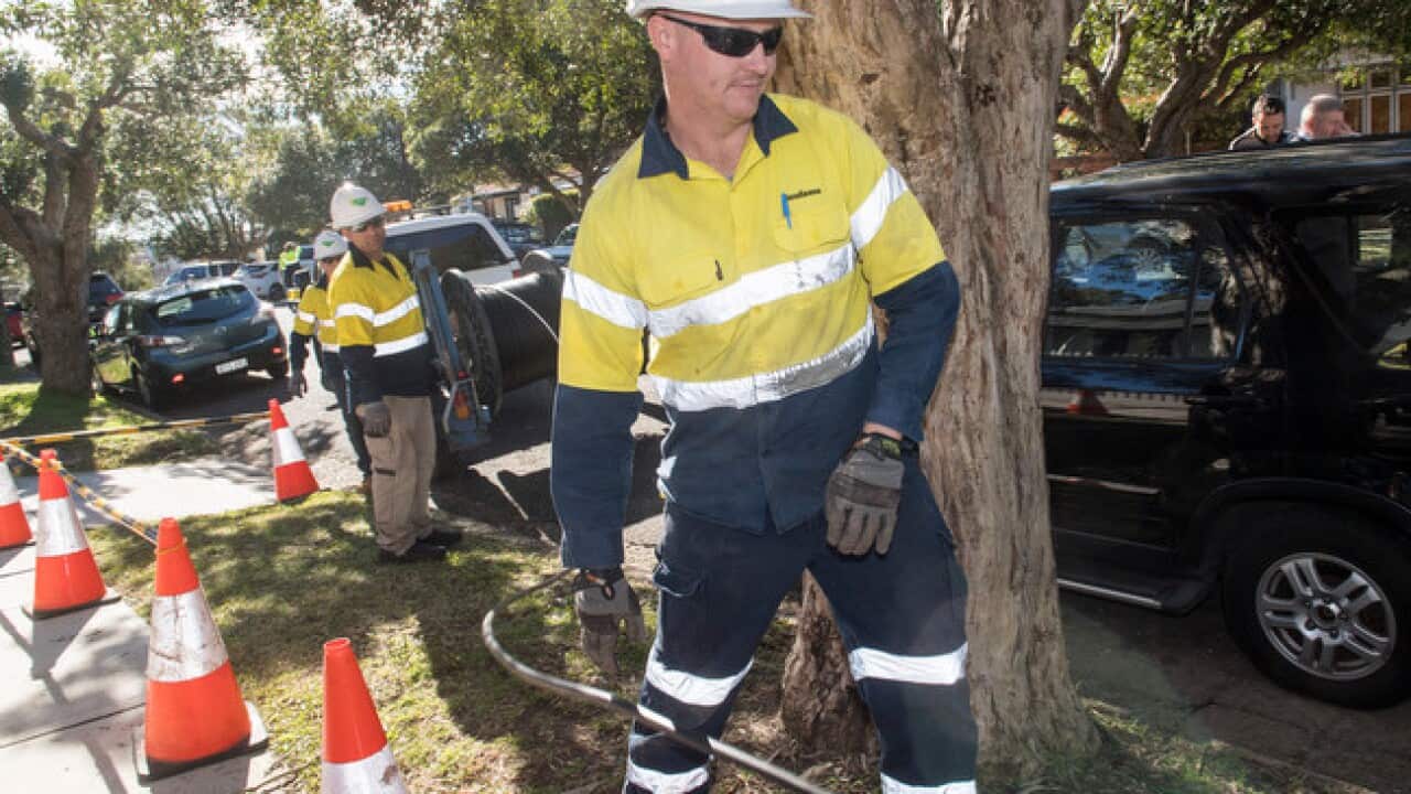 Contractors working with the rollout of the NBN network are seen in Sydney,