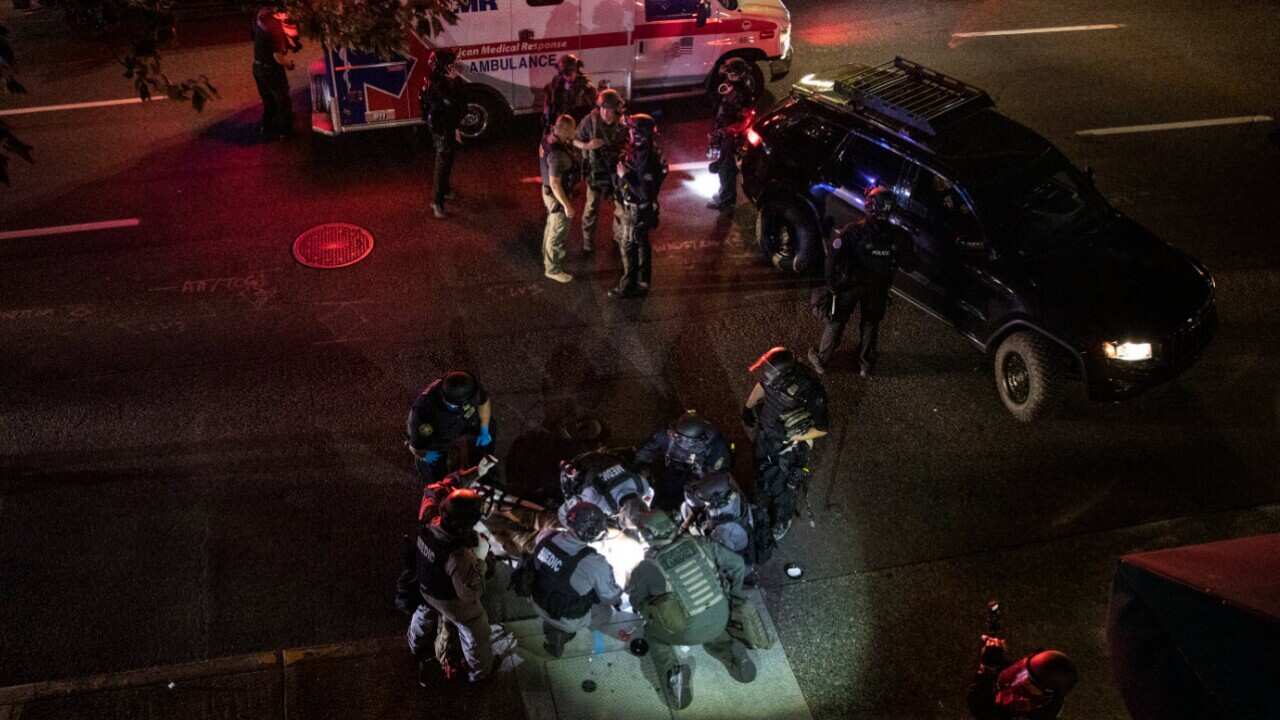 A man is treated after being shot Saturday 29 August, 2020, in Portland, Oregon.