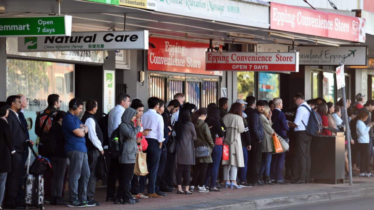 Commuters wait for buses at Epping train station in Sydney (AAP)