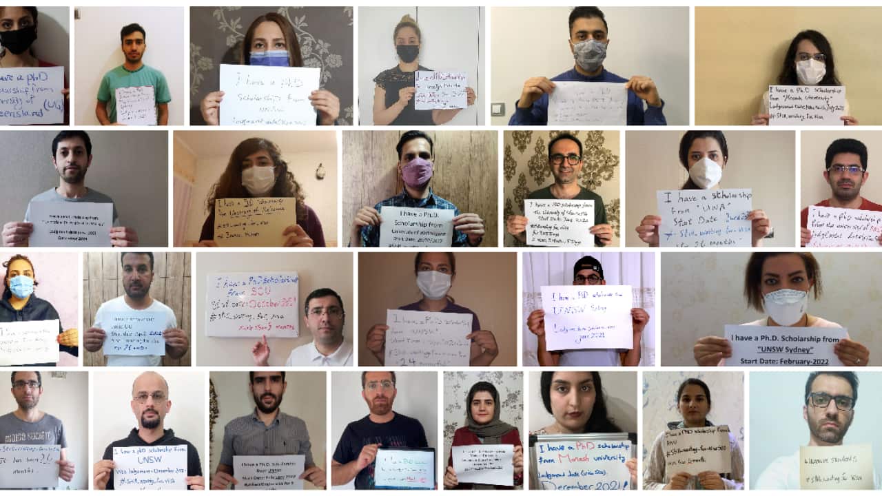 A group of people holding signs.