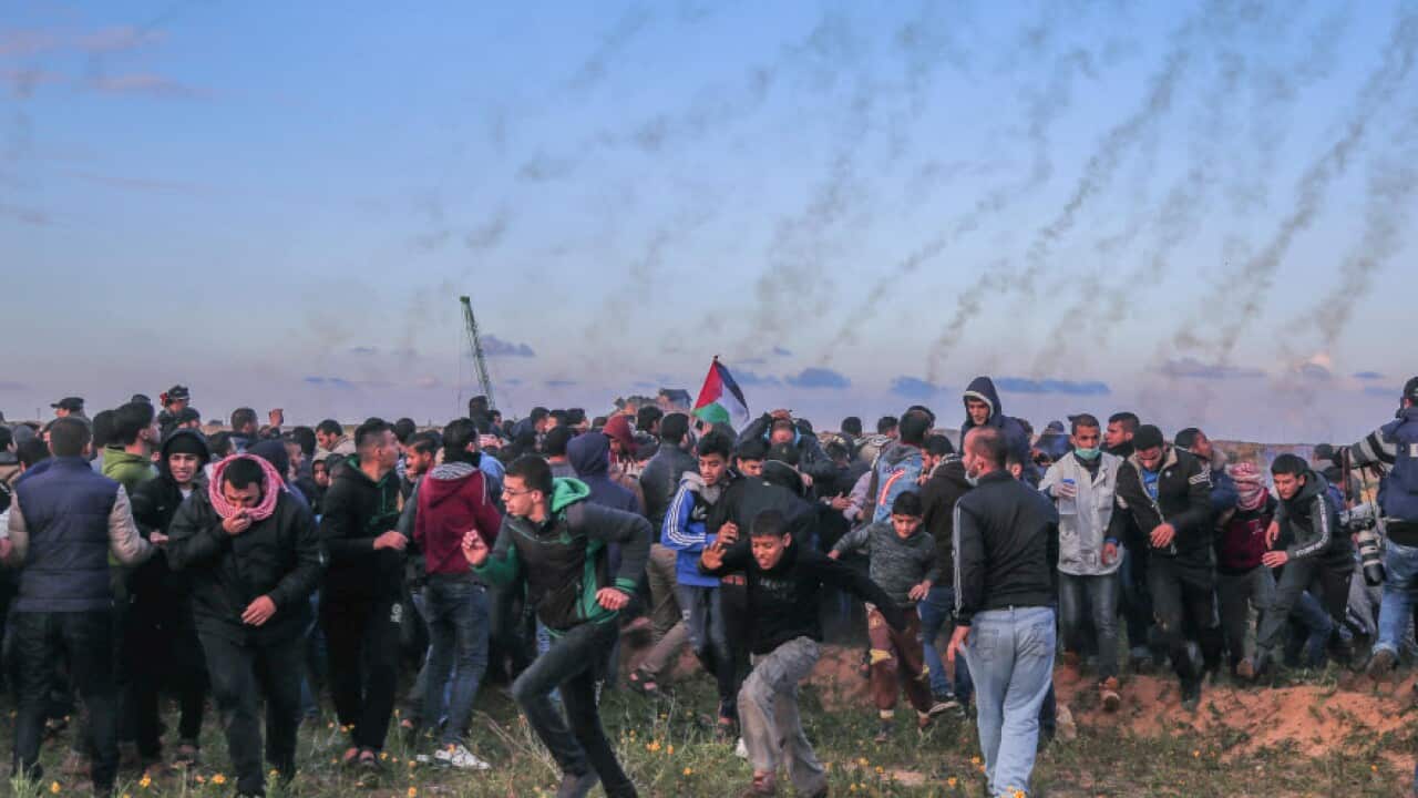 Tear gas is seen being fired by Israeli troops toward Palestinians during clashes