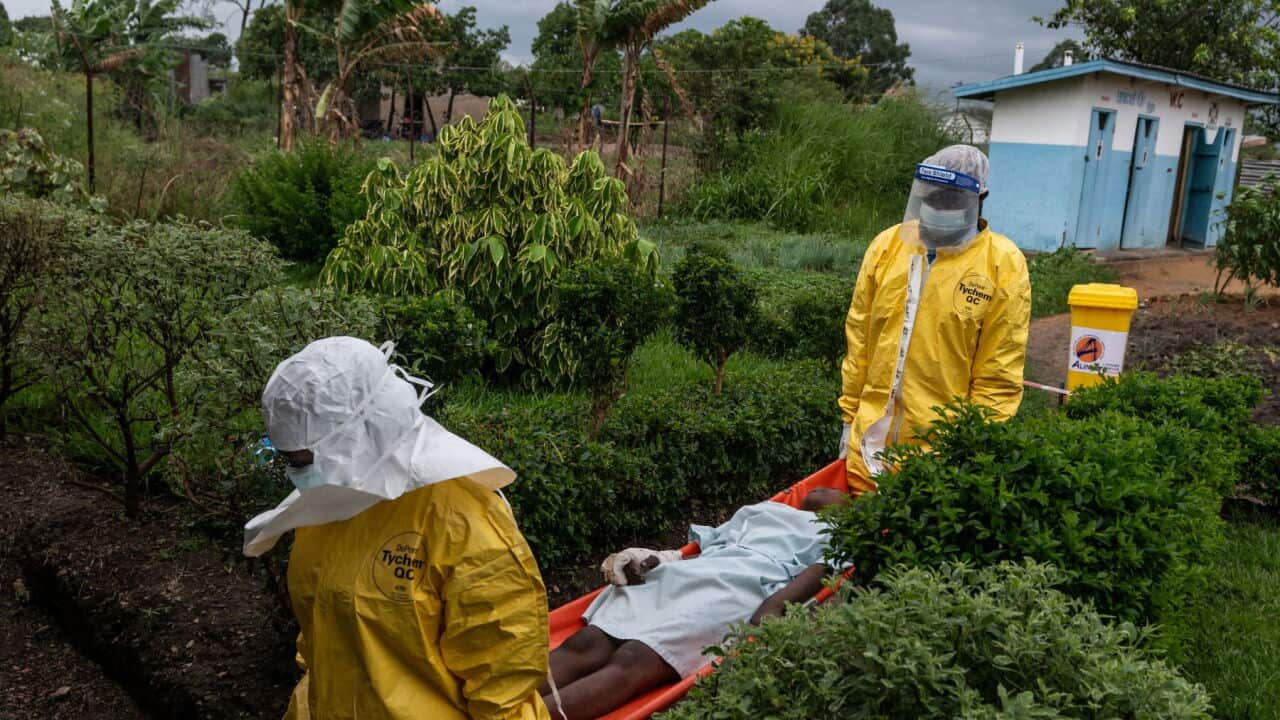 Medical staff carry an Ebola patient to a treatment centre in Rwampara, Congo (AP Photo-Moses Sawasawa).jpg