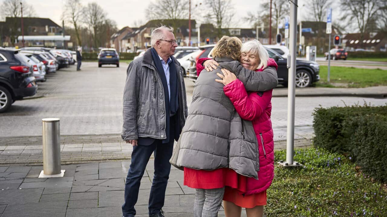 Relatives of victims of the Malaysia Airlines Flight 17 embrace as they arrive to watch a transmission of the court sessionat a congress center in Nieuwegein