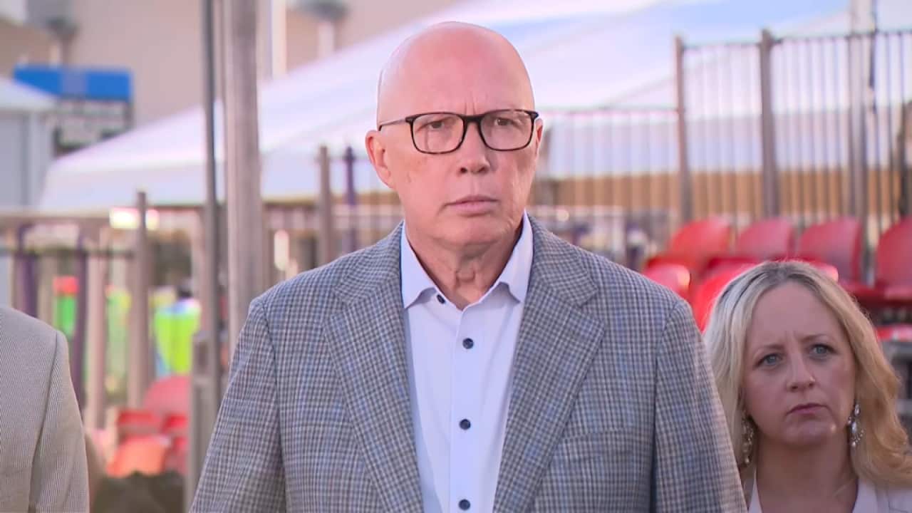 Man wearing checked blazer.