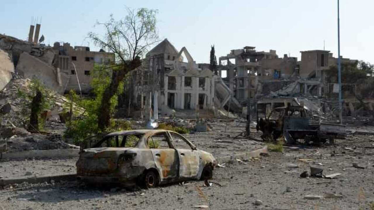 Damaged buildings and vehicles in Raqqa, Syria