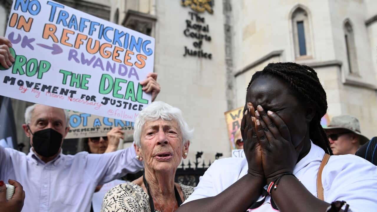 A woman covering her face with her hands