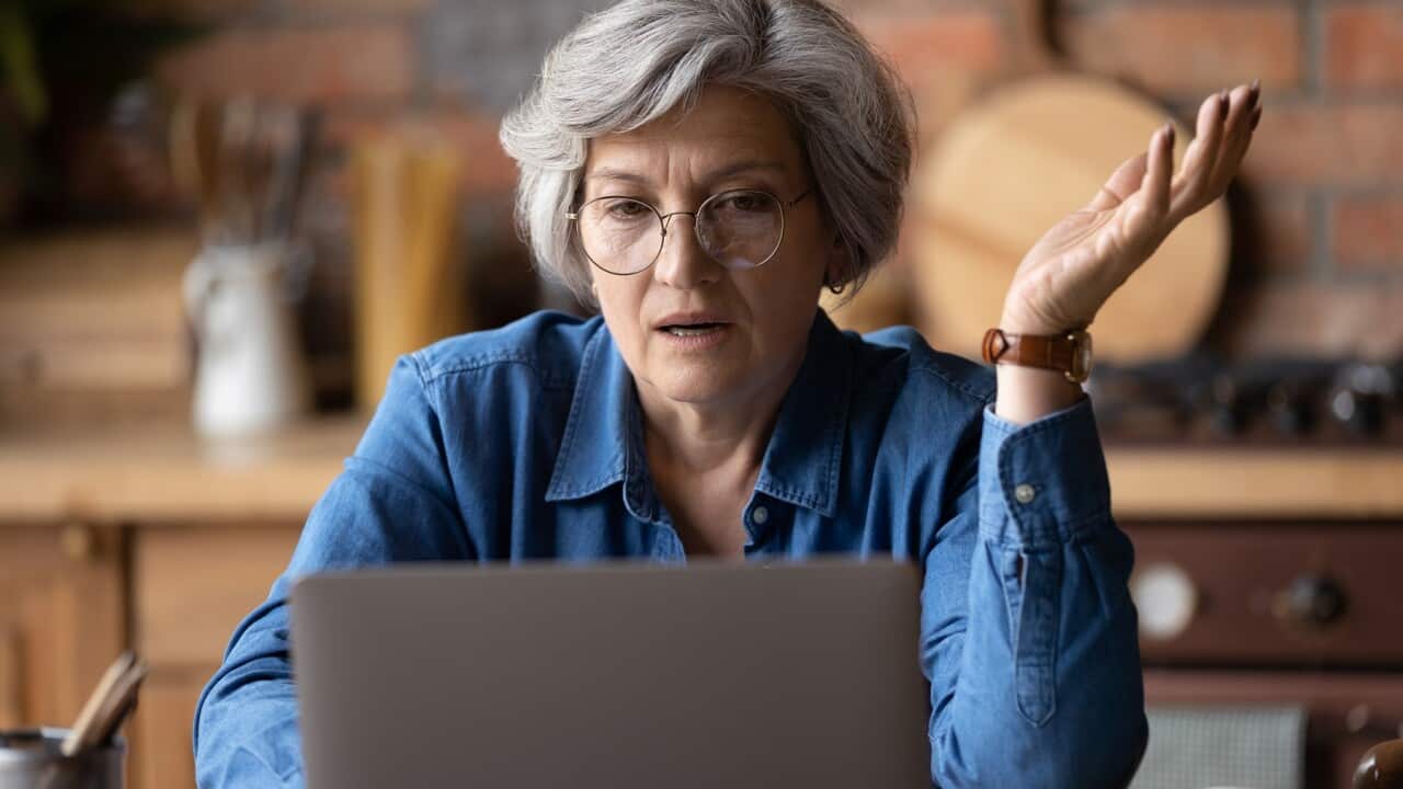 Confused woman looking at computer screen.