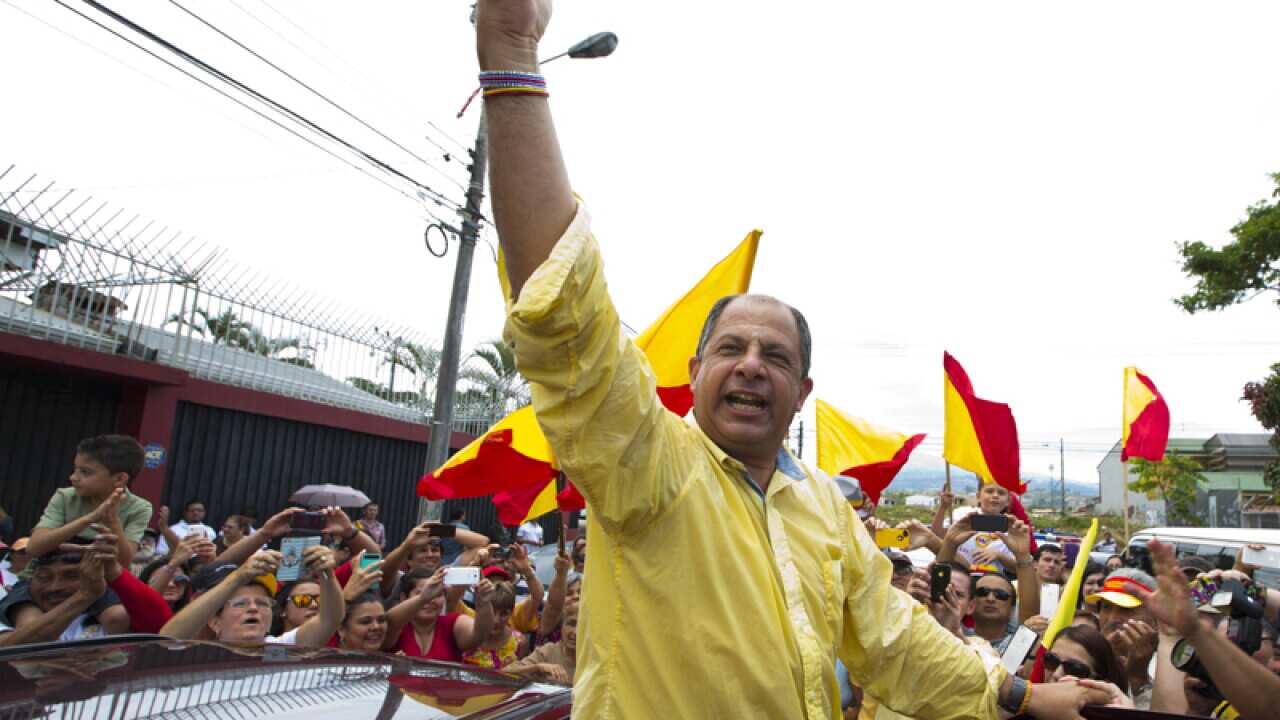 Luis Guillermo Solis celebrates.