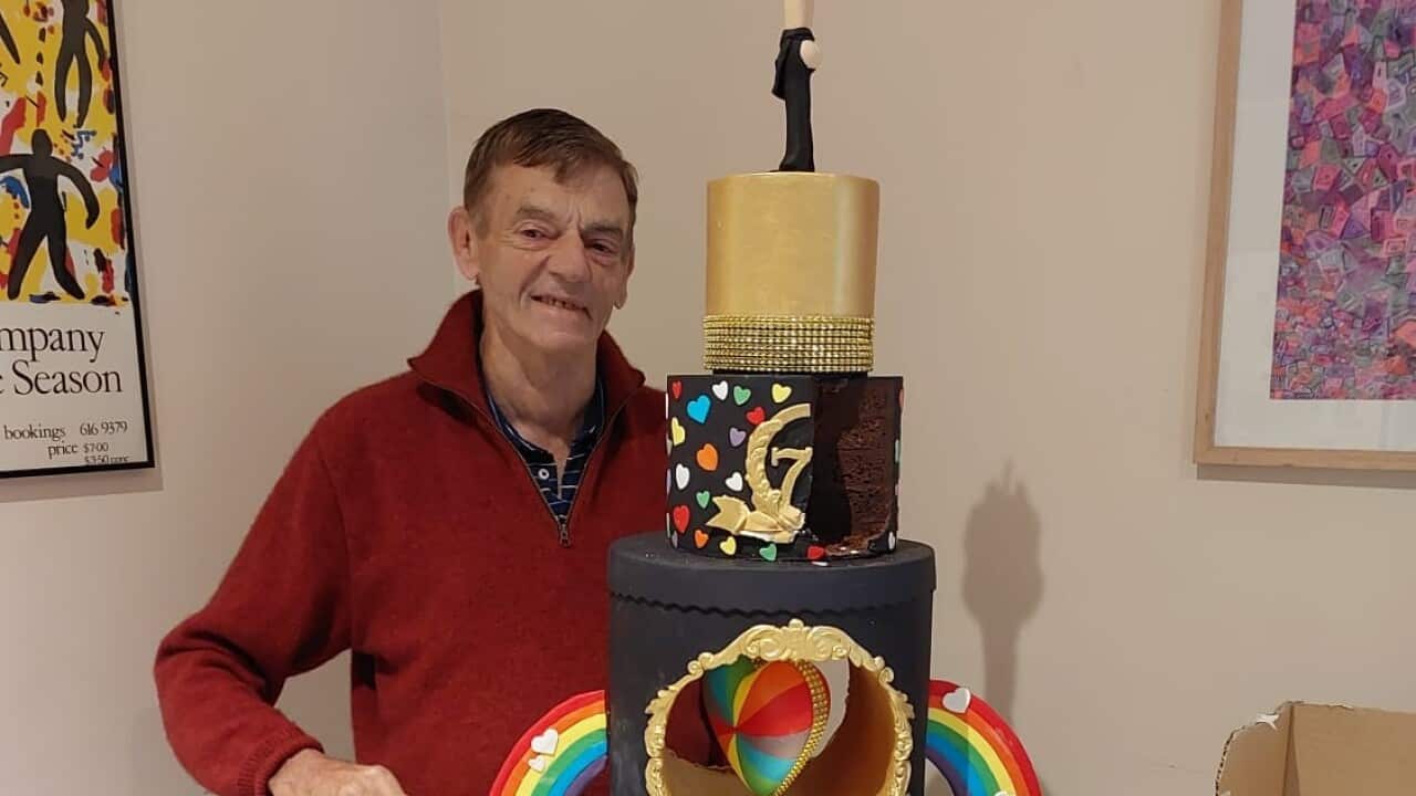 A man cutting a birthday cake