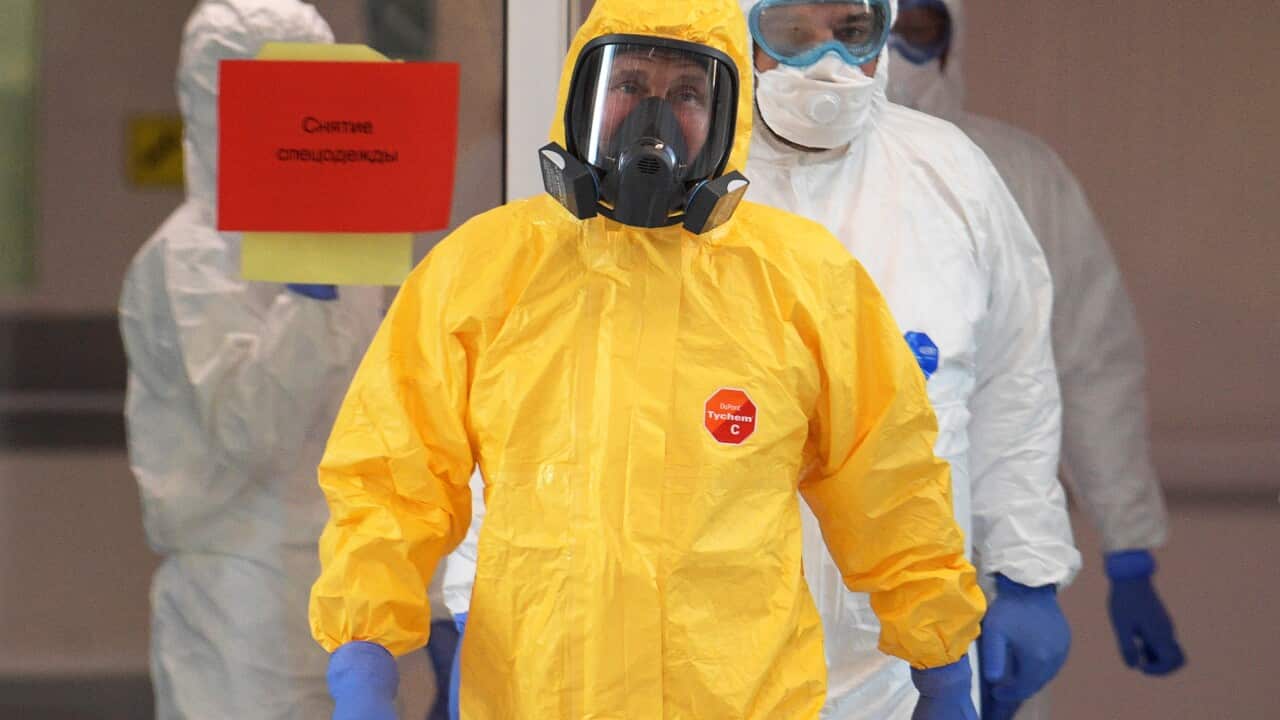 Russian President Vladimir Putin wearing a yellow protective suit visits a hospital for patients with suspected coronavirus.