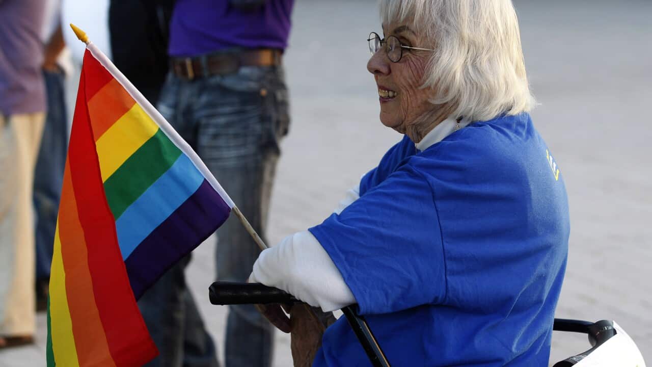 A woman holds a gay pride flag on October 6, 2014 in Salt Lake City, Utah. The U.S. Supreme Court declined to take up challenges to same-sex marriage making it legal now in Utah. (George Frey/Getty)