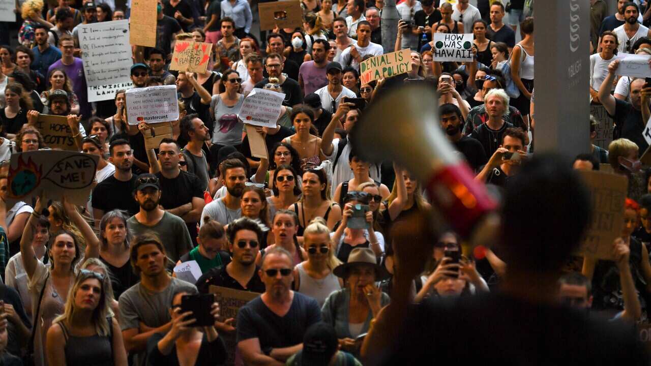Protesters march with placards during a 'Sack ScoMo!' climate change rally in Sydney, Friday, 10 January, 2020.