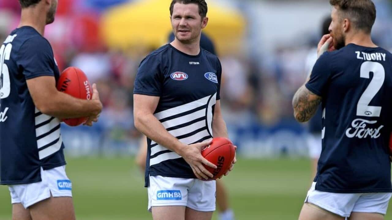 Patrick Dangerfield of the Cats chats with team mates