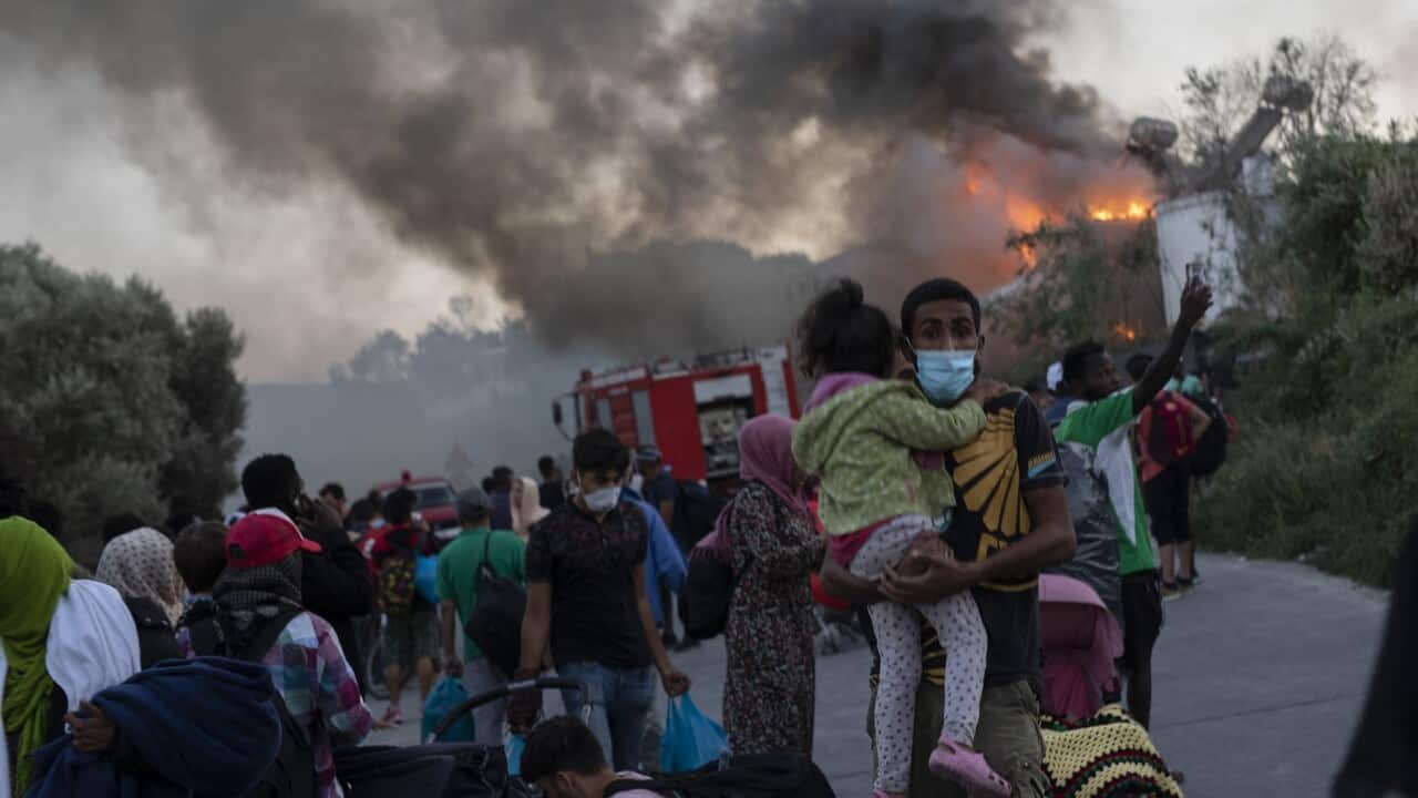 Migrants flee from the Moria refugee camp