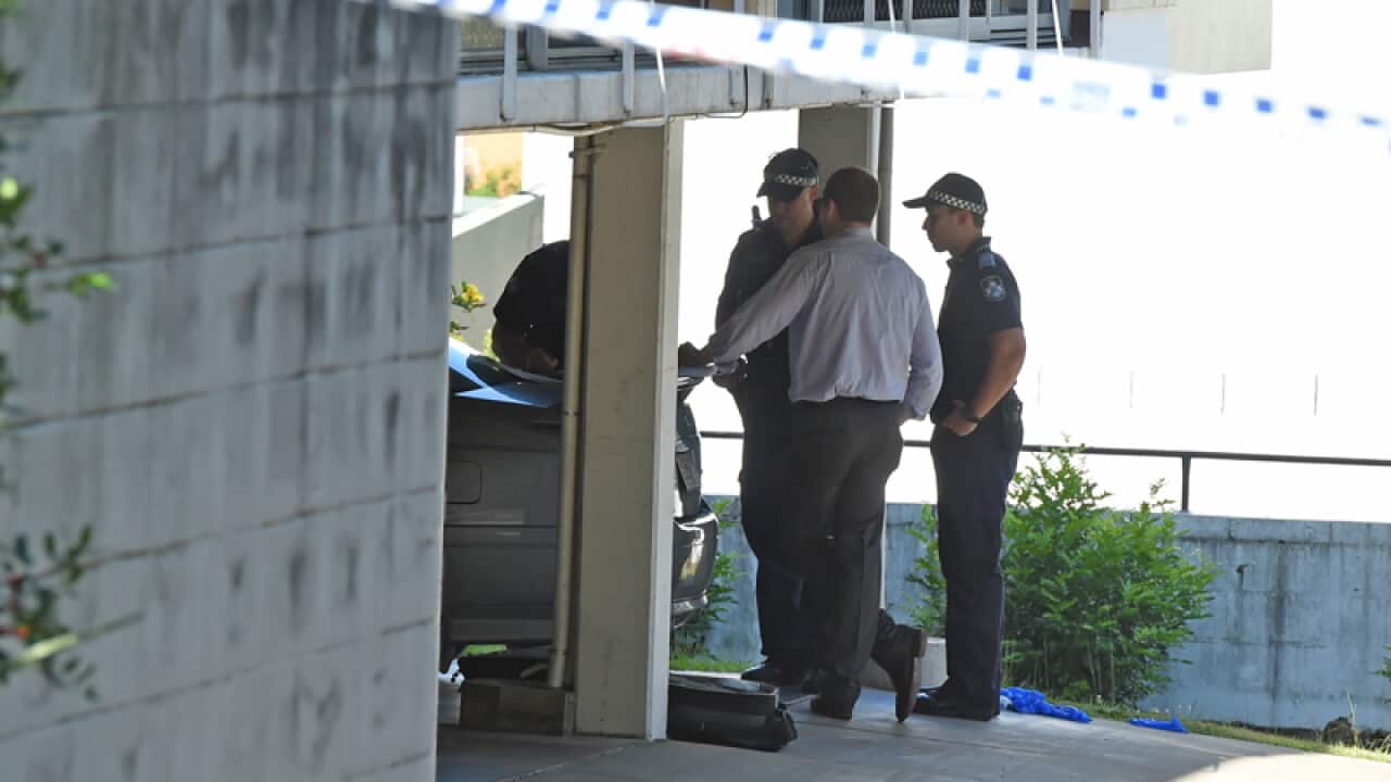 Police officers at an apartment complex in Toowong, Brisbane