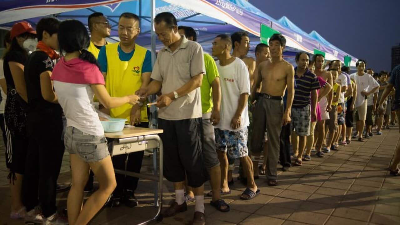 Chinese local residents are queuing up to register themselves as temporary refugees at a local school