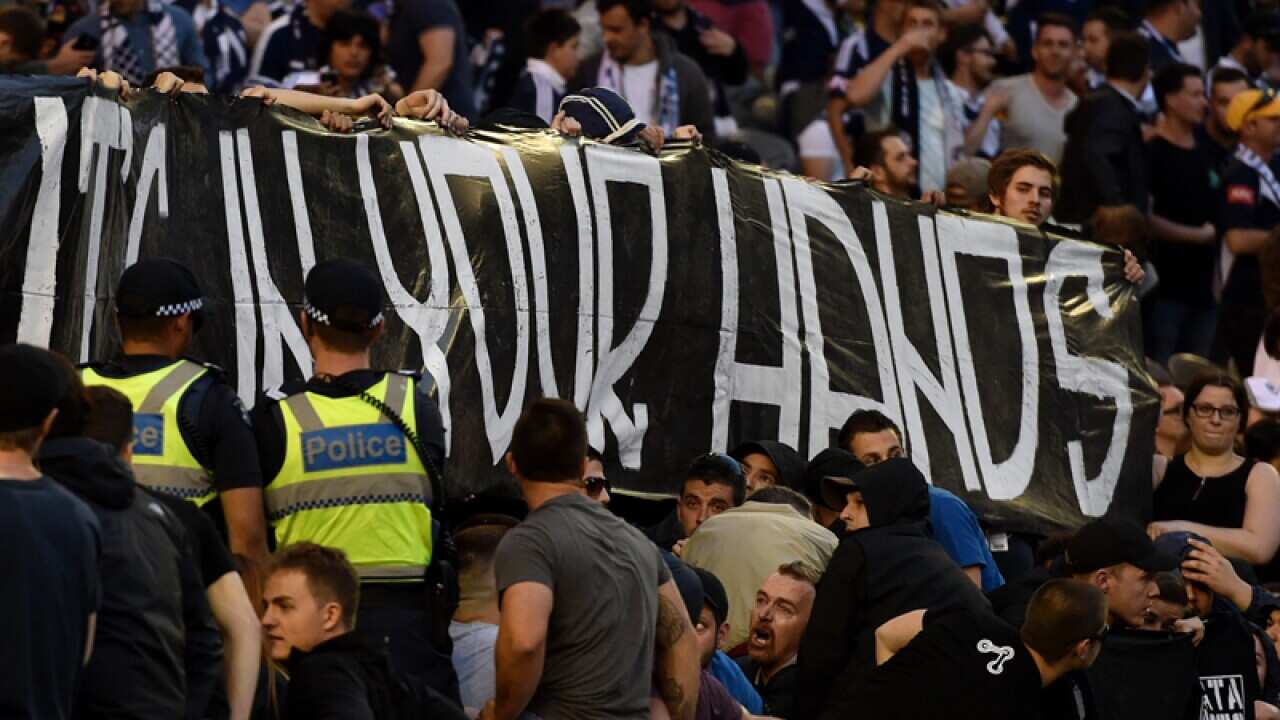 A Victory fans walk out on mass at the 30th minute in protest