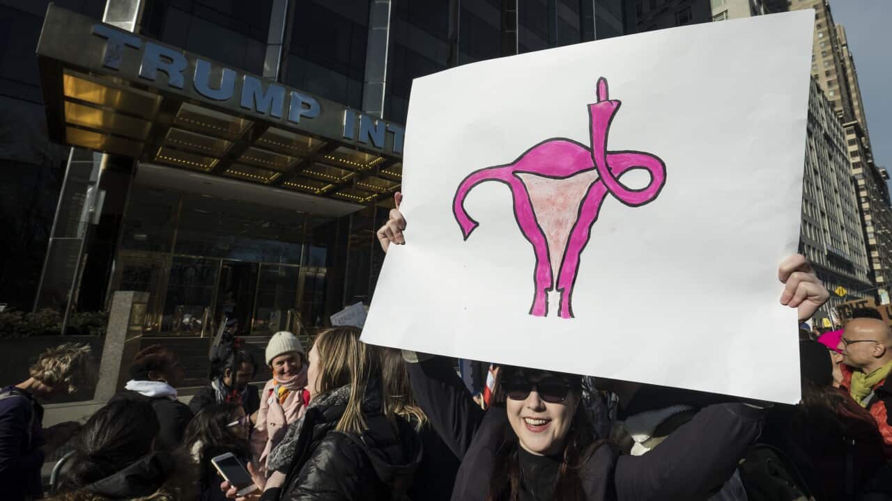 A woman with short hair with picture os men scratched out behind her.