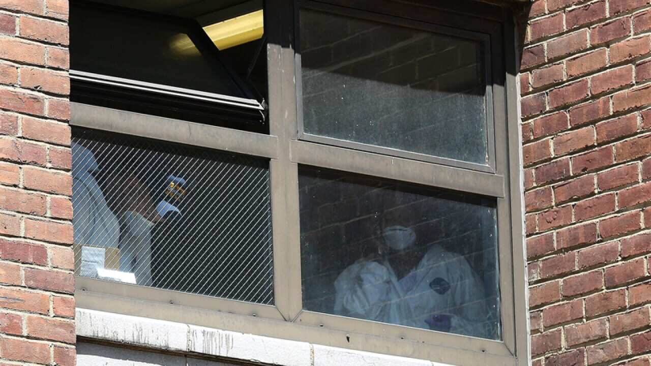 New York forensic officers work at the scene of a stabbing