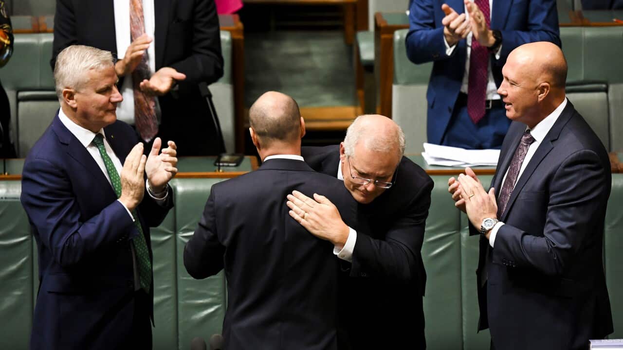 Prime Minister Scott Morrison congratulates Treasurer Josh Frydenberg after handing down his third Federal Budget,