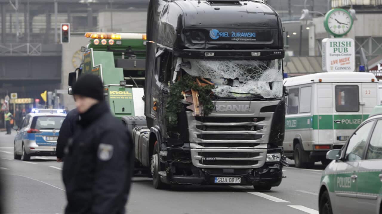 The damaged towing truck is towed away from the crime scene in Berlin