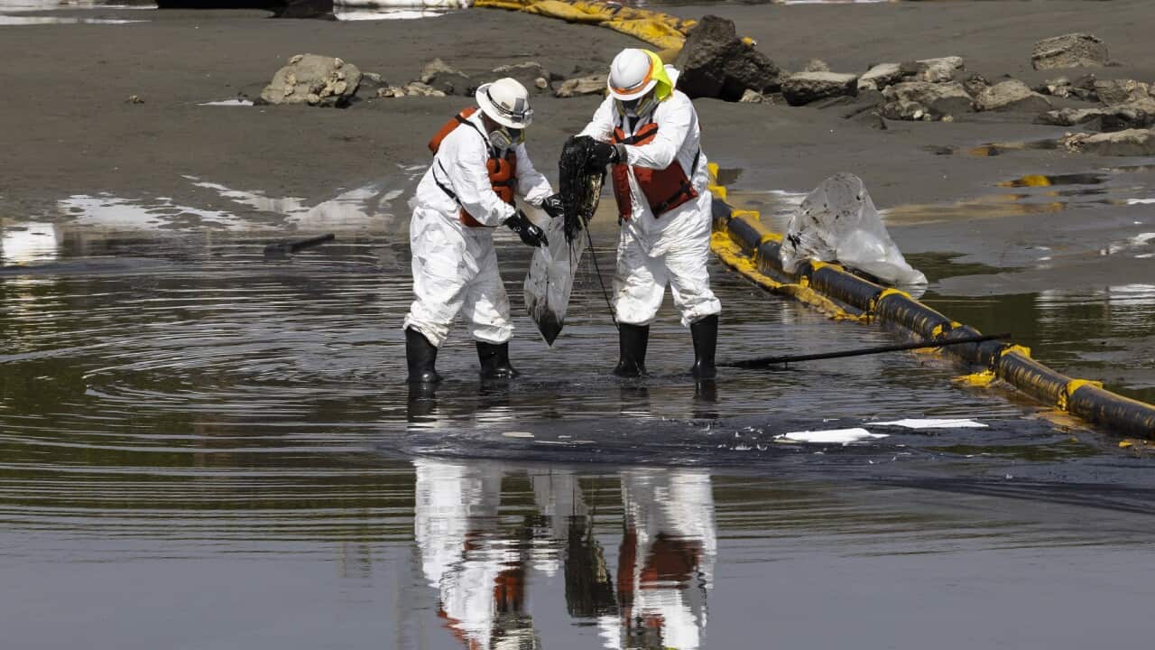 Crude oil spill clean up effort at Huntington Beach, California