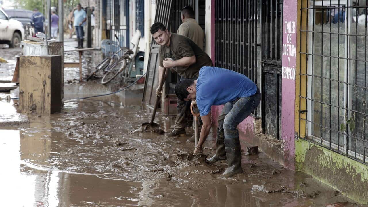 Residents remove mud from their houses in Upala, San Carlos, Costa Rica