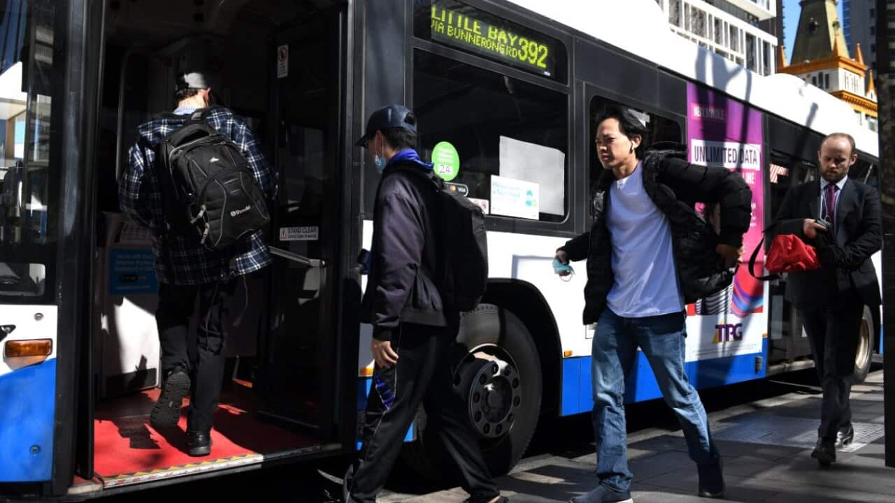 Commuters are seen boarding a bus in Sydney, Tuesday, 18 August, 2020.