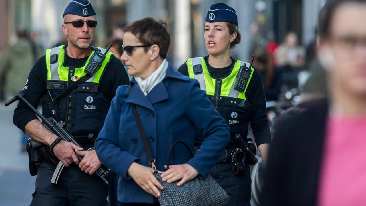 Police officers patrol on the Meir, the main shopping street, after police arrested man on suspicion of driving at a crowd in Antwerp, Belgium