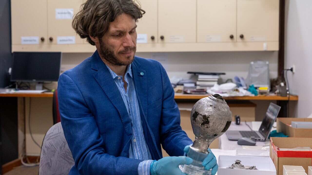 Arvi Wattel examining Batavia silver (Supplied Credit Jarryd Gardner).jpg