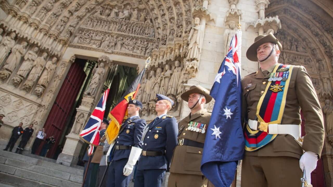 Soldiers carry flags during the commemoration marking the 100th anniversary of the Battle of Amiens, at Amiens Cathedral, France