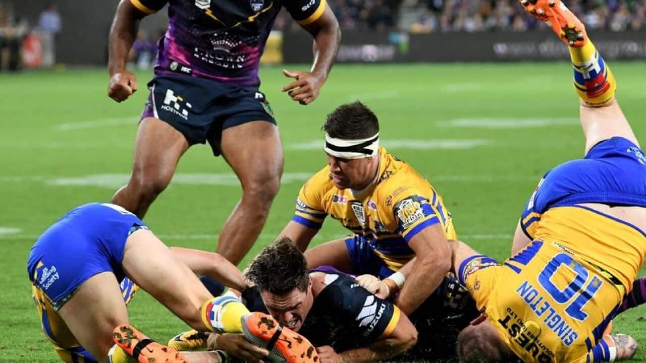 Melbourne Storm's Brodie Croft scores a try during a match.