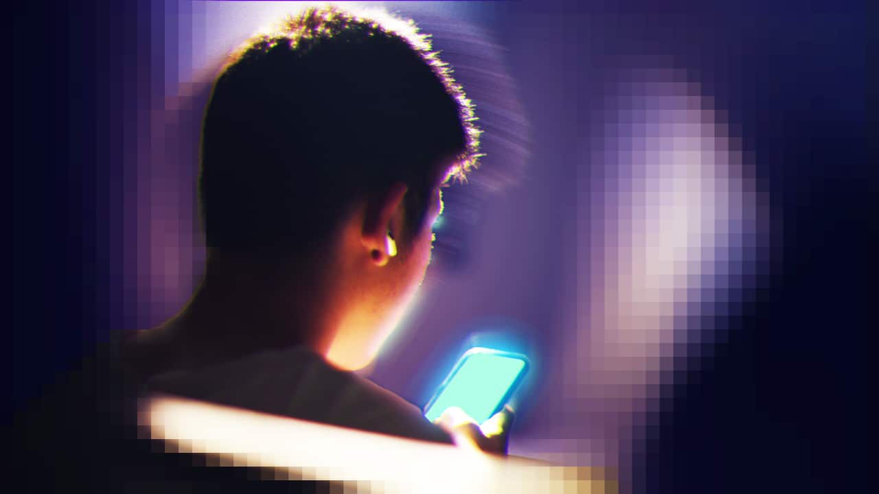 A boy scrolling on a phone.