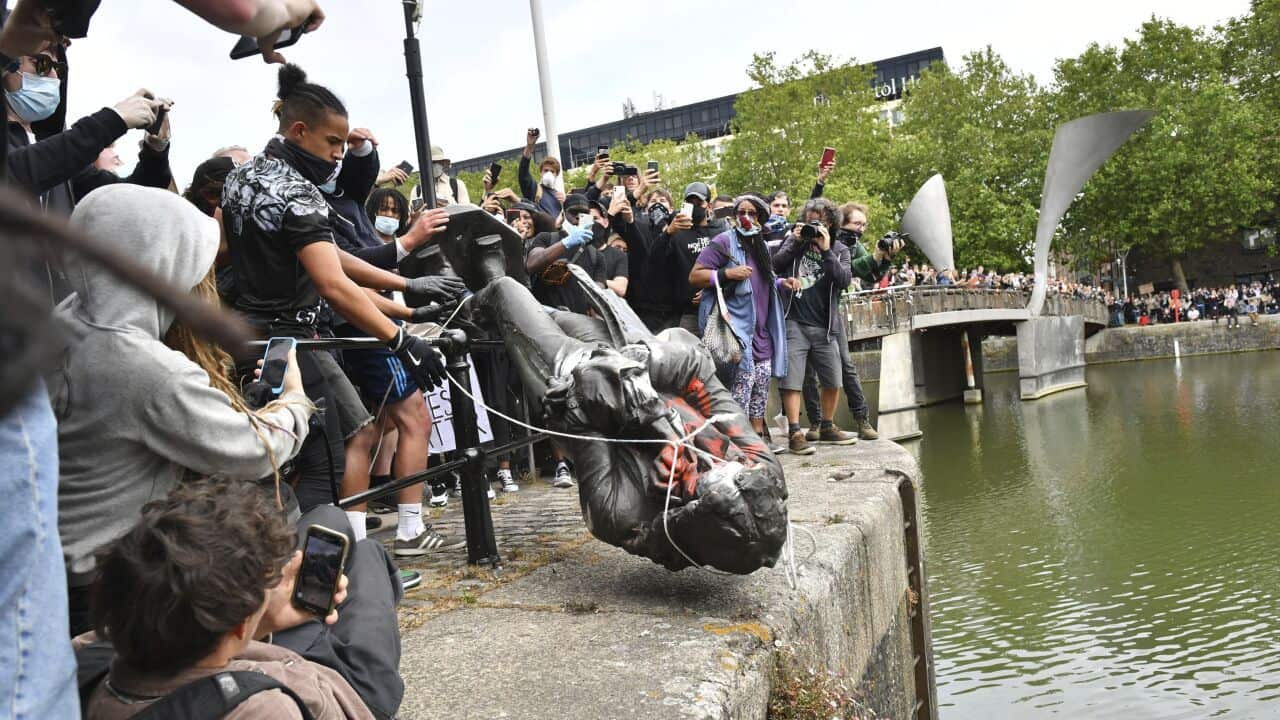 Protesters throw a statue of slave trader Edward Colston into Bristol harbour, during a Black Lives Matter protest rally