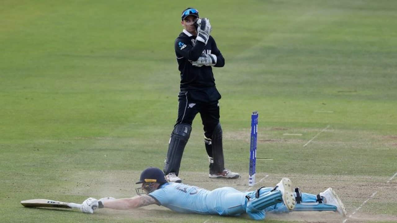 England's Ben Stokes dives in to make his ground and get a 6 from overthrows during the Cricket World Cup final match between England and New Zealand at Lord's cricket ground in London, Sunday, July 14, 2019.(AP Photo/Alastair Grant)