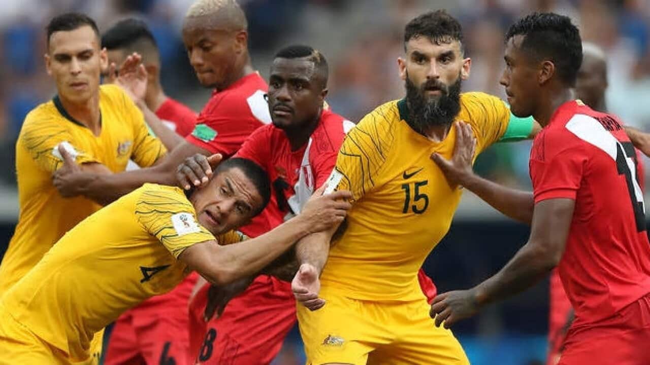 Tim Cahill, centre, and Mile Jedinak, right, in action during the Socceroos' loss – Getty Images.