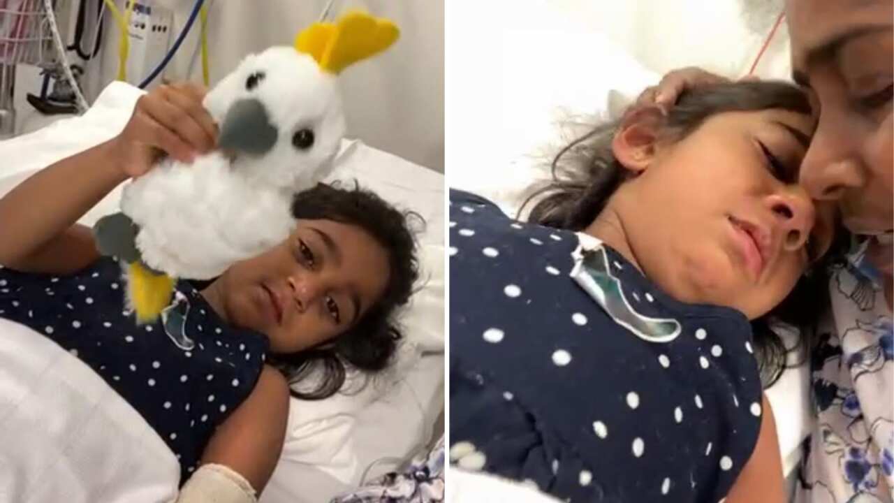 Tharnicaa, 3, and her mother Priya, facetime family friend Angela Fredericks from hospital in Perth.