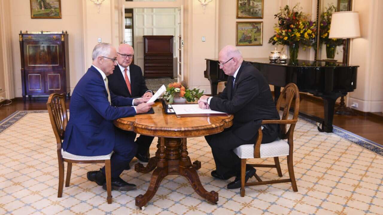 Malcolm Turnbull and George Brandis look on as Sir Peter Cosgrove signs Marriage Amendment Act (AAP)