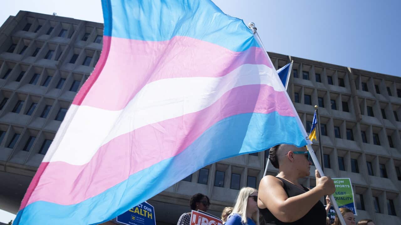 Advocates for the rights of transgender people rally outside the headquarters of the US Department of Health and Human Services.