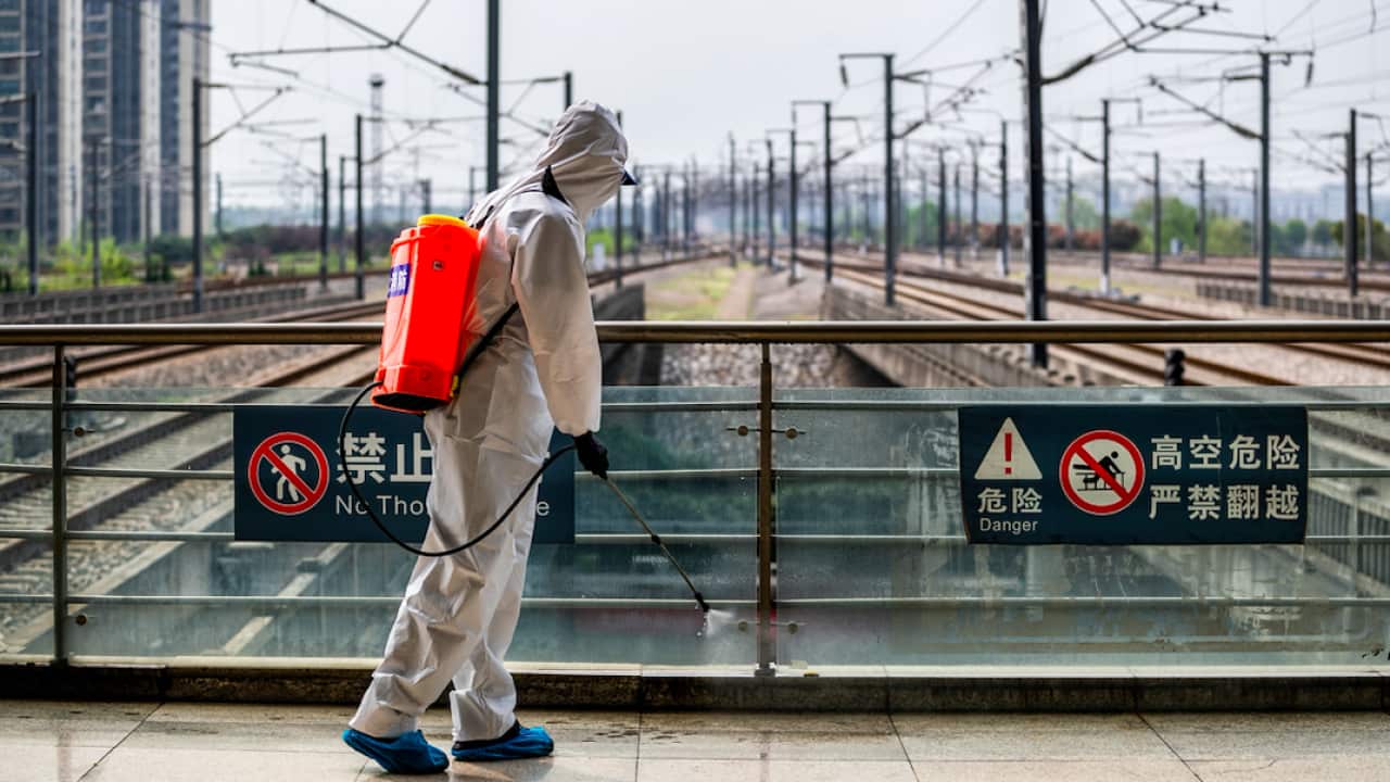 A staff member sprays disinfectant at Wuhan Railway Station this week.