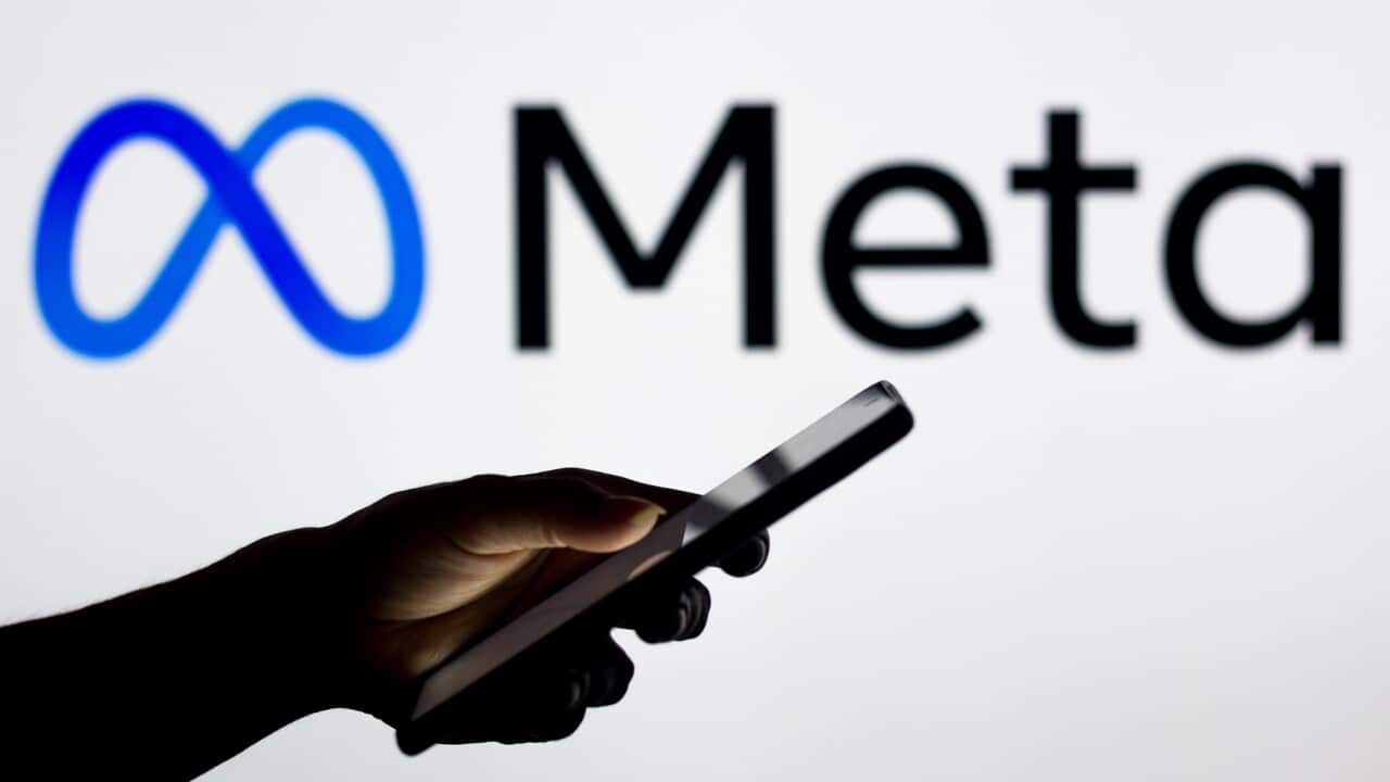 In this photo illustration the Meta Platforms logo seen in the background of a silhouette woman holding a mobile phone. (Photo by Rafael Henrique / SOPA Images/Sipa USA)