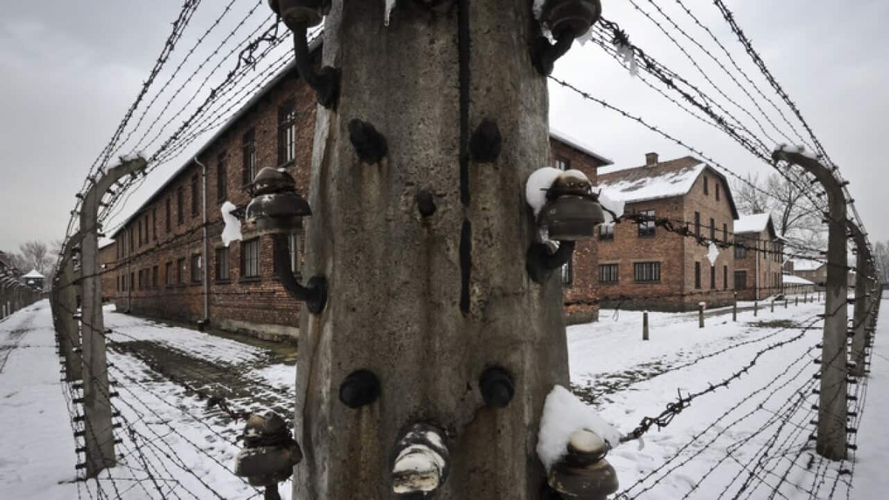 Barbed wire fences surround detention buildings at the Auschwitz Nazi death camp