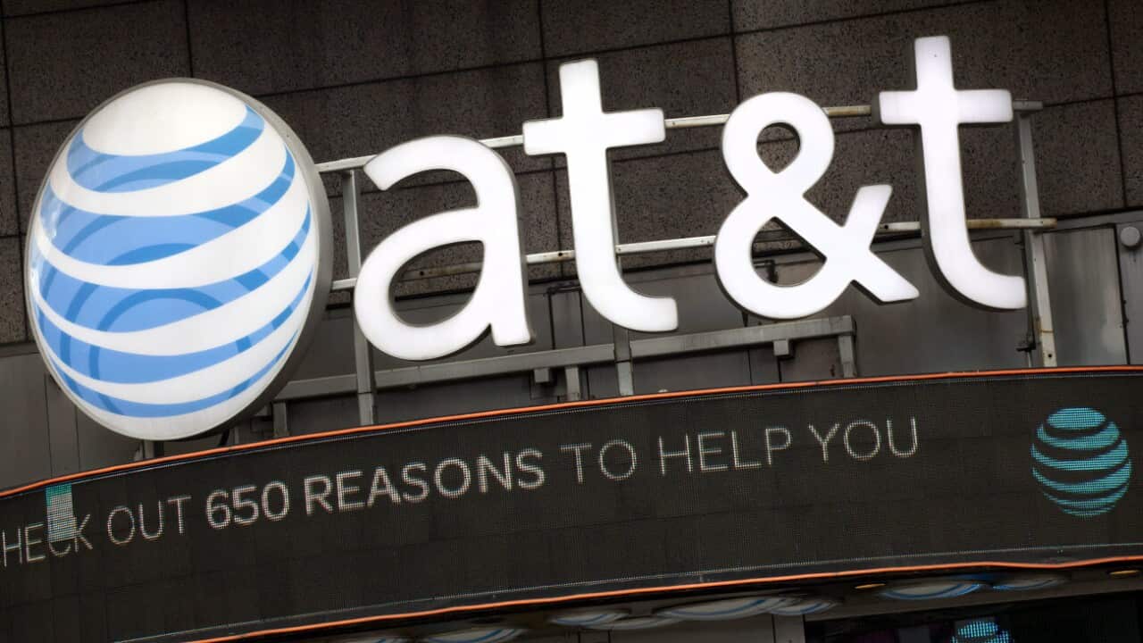 n this Monday, Oct. 24, 2016, file photo, the AT&T logo is positioned above one of its retail stores in New York.