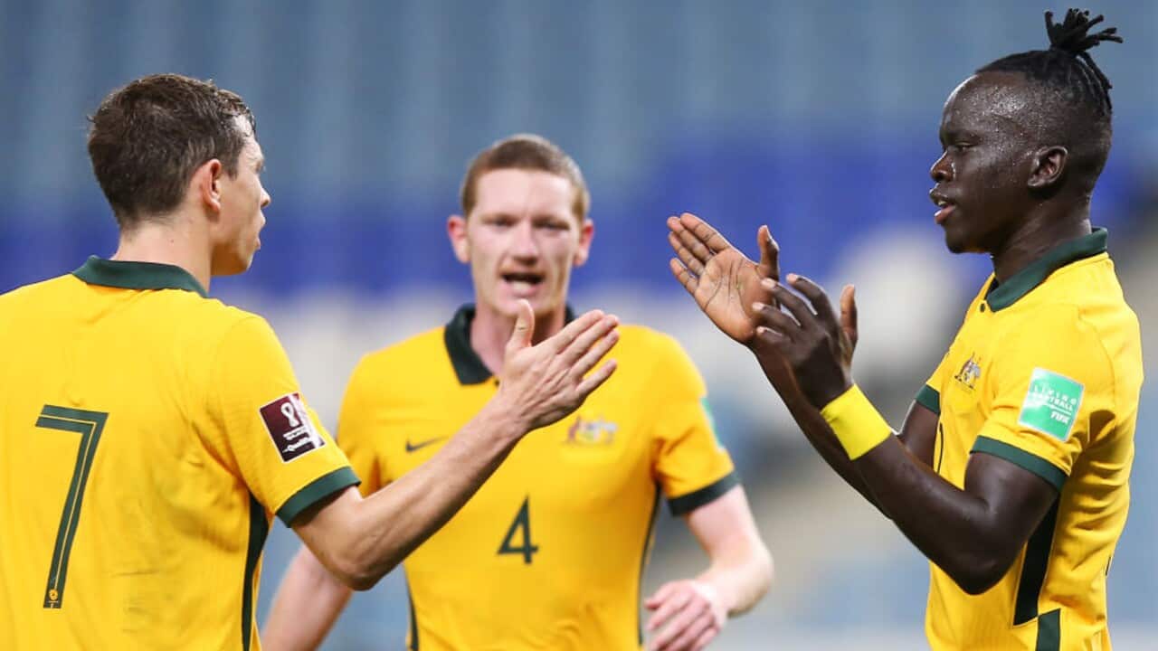 Awer Mabil (R) celebrates a goal for the Socceroos